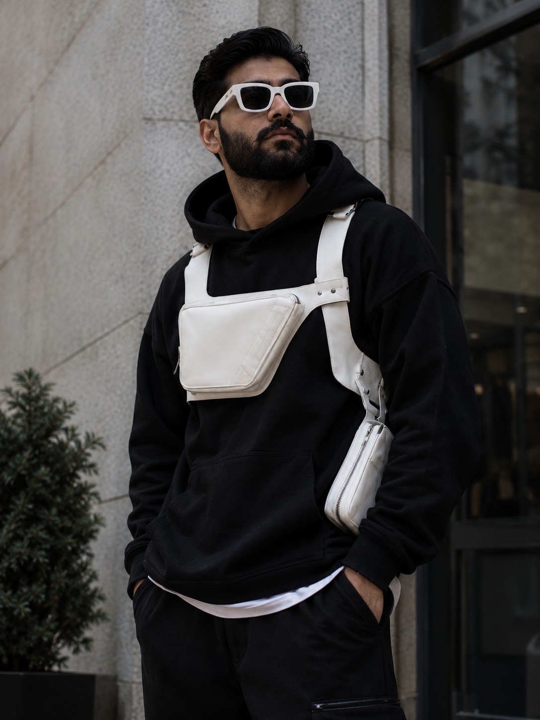 The Tech Vest in Bone White — worn on body over a hoodie with the chest pouch and drop-leg pouch